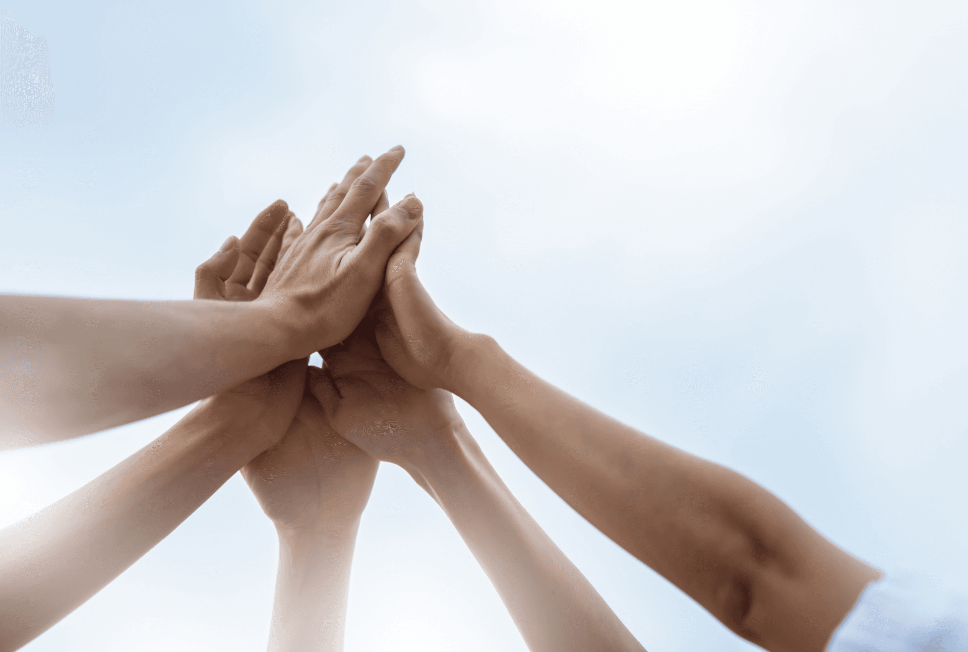 hands in together highfiving into the sky