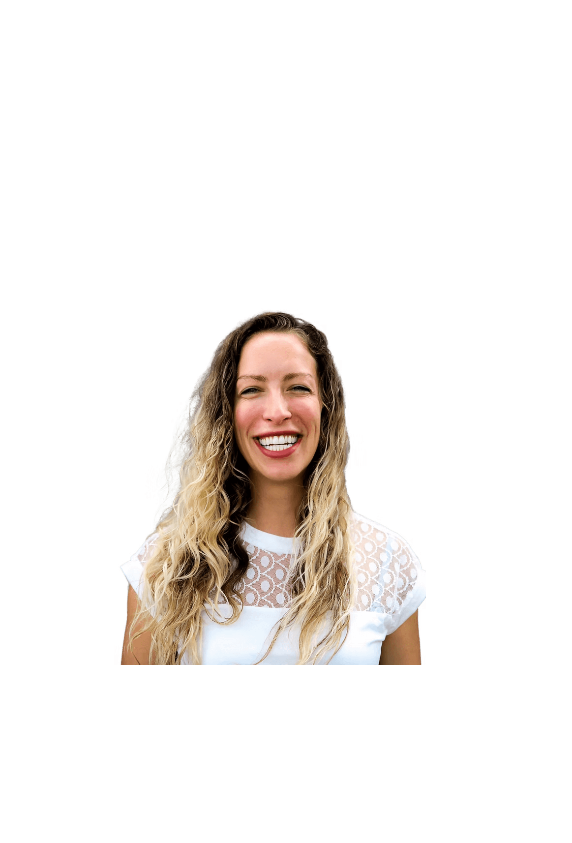 Woman with long wavy blonde hair smiling at camera against black background, wearing white lace-trimmed shirt